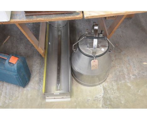 A milking unit complete with a stainless steel trough and a measure stick.