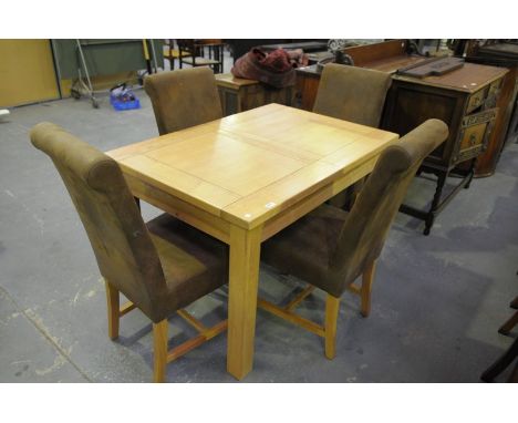 A Modern light oak extending dining table with 4 suede effect dining chairs.(5)