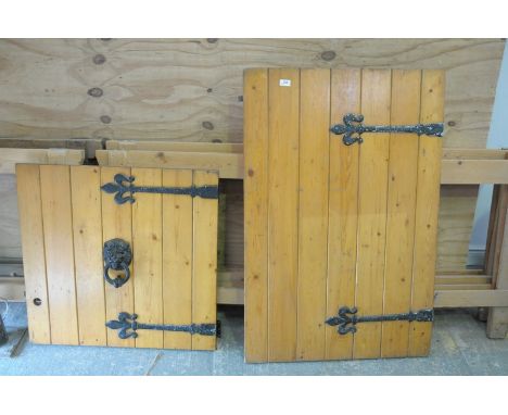 A vintage pine double section door, with door knocker and fleur de lys black painted hinges.