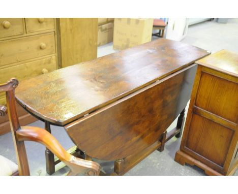 A Reproduction 18th century style oval drop leaf dining table on ring turned supports.