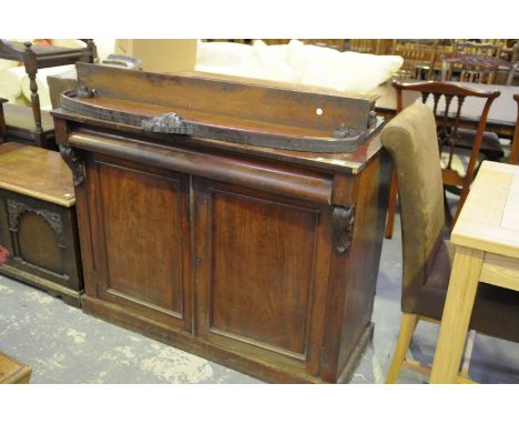 A 19th century mahogany chiffonier, the raised back with a shell leafy crest above a single shelf, rectangular top, single fr