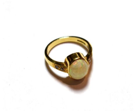 An 18 carat gold opal ring, finger size Q.  Gross weight 6.1 grams.