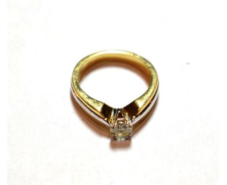 A diamond solitaire ring, stamped '750', finger size N1/2.  Gross weight 7.3 grams. 
