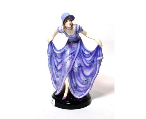 An Art Deco Goldscheider figure, designed by Stephen Dakon, modelled as a dancer, wearing a floral printed dress, on circular