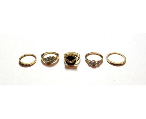 Four assorted 9 carat gold gemset rings including two diamond set examples, a ruby and diamond example etc; and a cat motif e