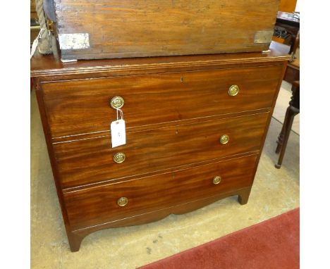 A Georgian mahogany chest of three graduated drawers raised on shaped bracket supports with brass handles