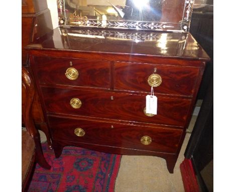 A Georgian mahogany chest having two short above two long drawers with oval brass handles on bracket feet