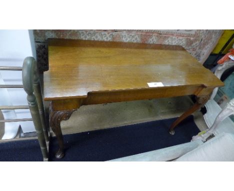 A George III style console table the shaped top raised on carved pad foot