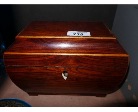 A sarcophagus wooden tea caddy opening to reveal two lidded compartments