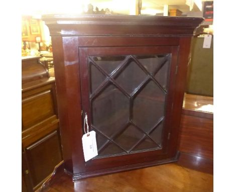 A mahogany corner with glazed panel enclosing shelf