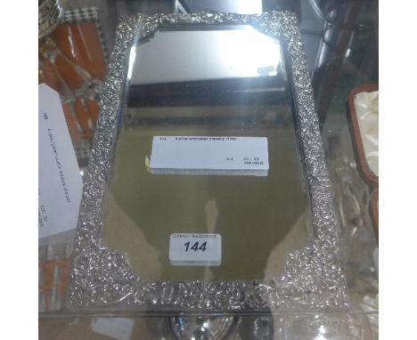 A silver embossed dressing mirror