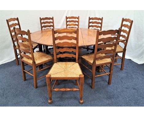 IMPRESSIVE YEW GATELEG DINING TABLEwith shaped drop flaps, standing on turned supports united by a stretcher, 157cm wide, tog