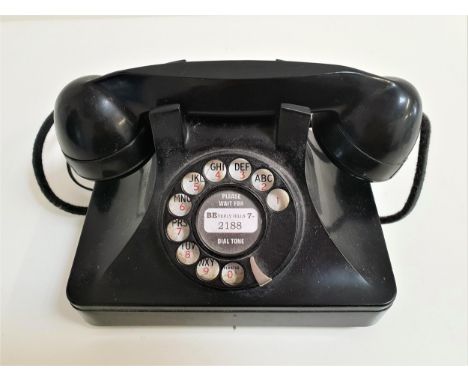 VINTAGE BAKELITE TELEPHONEwith a rotary dial and handset, with current socket fixing 