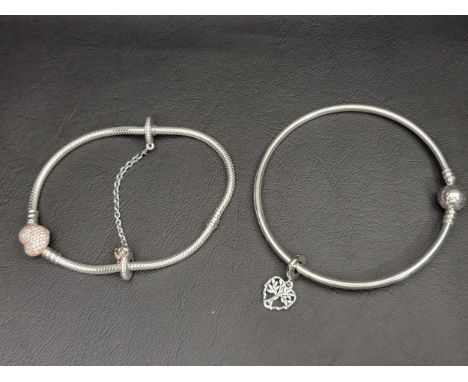 TWO PANDORA BRACELETS comprising a Pandora Moments Bangle with a Heart Family Tree Dangle Charm and a Pandora Moments Pave He