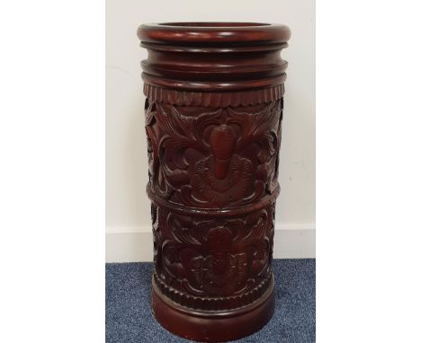 CARVED TEAK STICK STANDof cylindrical form with floral decoration, 60cm high 