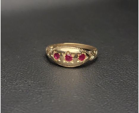 PRETTY RUBY CLUSTER RINGthe three round cut rubies set in a polished marquise setting with decorative shoulders, on nine cara