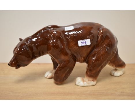 A large ceramic study of a brown bear, striding on all fours, makers mark for 'Charisma, made in England', h19cm  Condition r