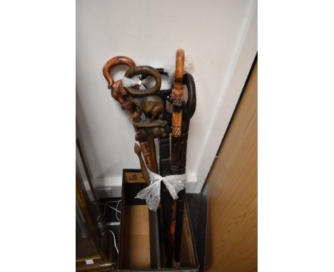 A hard wood walking stick with carved elephant handle, H93cm, sold together with various other carved wooden walking sticks, 