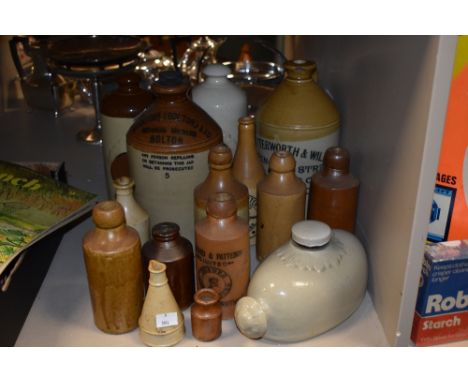 A selection of stoneware jugs and glasses including one titled 'Stantons (Bolton) Ltd' Botanical Brewers Bolton and another '
