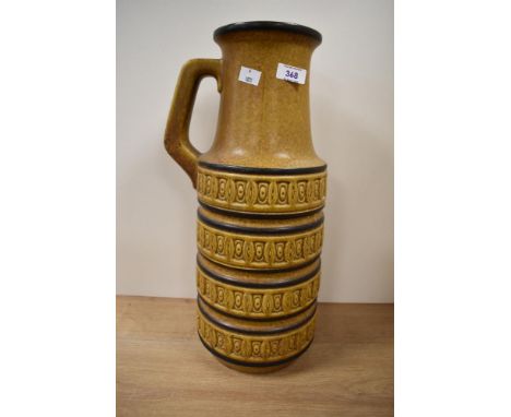 A large vintage West German vase with handle, having geometrical patterns on a mustard ground, h45cm