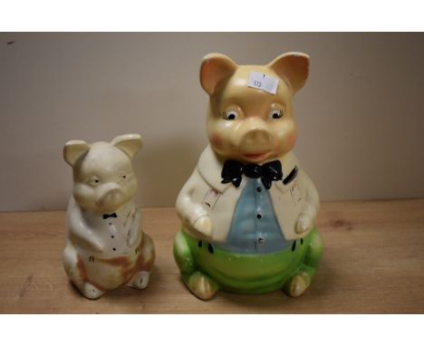 A pair of mid-century ceramic piggy banks, modelled as comical father pig and baby pig, hand coloured, largest H23cm