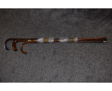 Two vintage walking canes and a walking stick with applied souvenir plaques