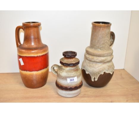 A West German ceramic vase decorated with a red drip glaze on a brown ground, impressed pattern number 404-20, h26cm, sold to