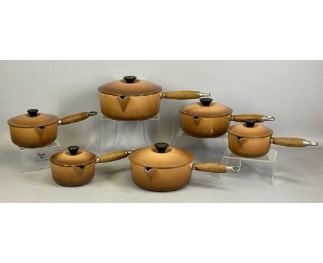 LE CREUSET SET OF SIX GRADUATED CAST IRON & BROWN ENAMEL SAUCEPANS with wooden handlesProvenance: private collection Gwynedd