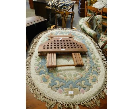 CHINESE THICK PILE OVAL WOOL CARPET WITH FLORAL BORDERS TOGETHER WITH A FURTHER HARDWOOD LATTICE TOP HEXAGONAL FOLDING TABLE 