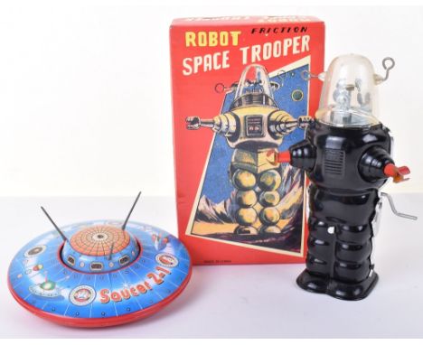 Modern (Made in China) boxed friction driven Robot Space Trooper, black tinplate robot with clear plastic helmet and hand cra
