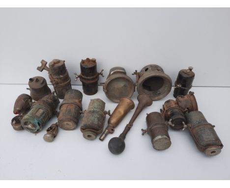 A selection of Vintage lighting and sparesincluding various carbide generators, a 1920s P&amp;H headlamp, two bulb horns and 