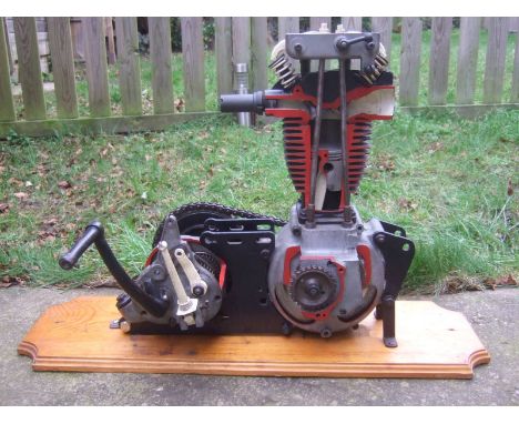 A 1930's BSA 250cc cutaway engine and gearboxwith operational valves, gears and clutch, mounted on a pine plinth measuring 30