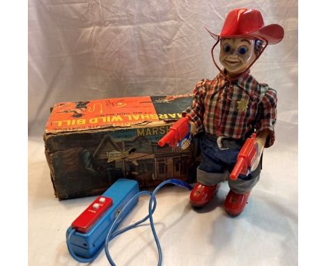 Tinplate: A vintage battery operated, Marshall Wild Bill, working order, with part box badly worn.