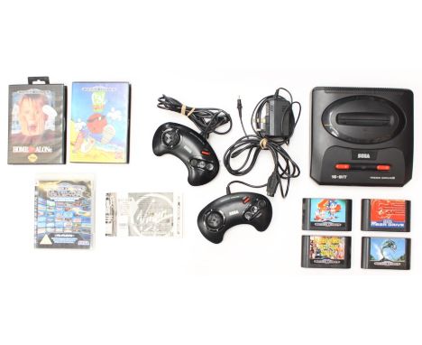 Sega: An unboxed Sega Mega Drive console, with two controllers and power supply; four unboxed games including: Mega Games 2, 