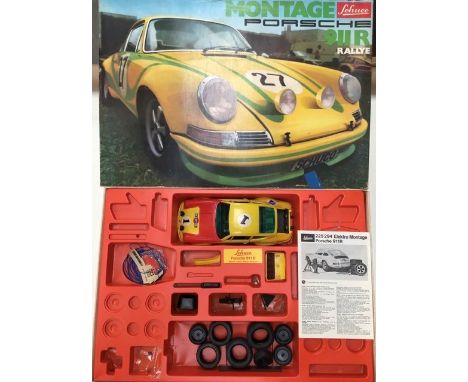 Schuco: A boxed Schuco Montage Porsche 911R Rallye. Ref 225 294. 1:16 scale kit in assembled condition, complete with instruc