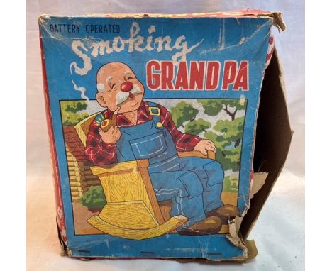 Tinplate: A vintage battery operated Smoking Grandpa, Made in Japan by Marusan, in good working condition, original box with 