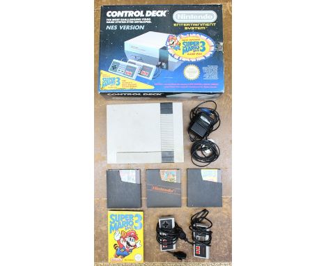 Nintendo: A boxed Nintendo Entertainment System Console, in need of a clean, appears complete but no internal packaging or in