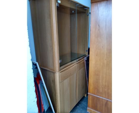 A modern Ercol display cabinet, with glazed doors over two drawers and further cupboard doors, 90x44x185cmH