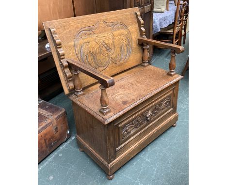 A 20th century oak monk's bench, with carved decoration, 85x46x81cmH 