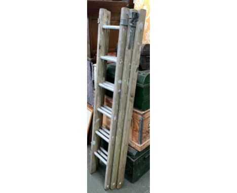 A wooden three piece extending ladder, with aluminium rungs 