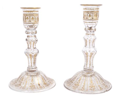 Pair 18th century gilded and cut glass candlesticks with knopped and faceted stem on bell-shaped foot, with painted gilt leaf