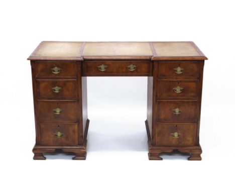18th century-style walnut crossbanded kneehole desk with leather inset top and nine graduated drawers about the kneehole, on 