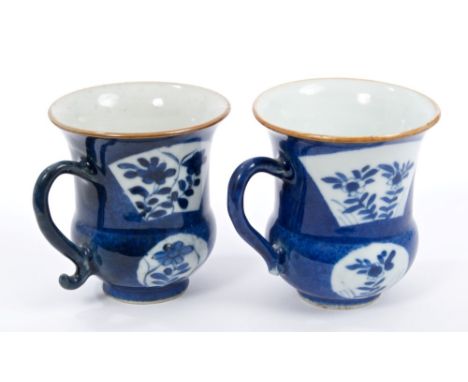 Pair 18th century Chinese Kangxi blue and white cups of bellied form, with scroll handles, fan-shaped floral reserves on blue