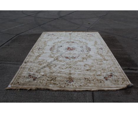 Large French-style carpet with cream ground and central floral bouquet with radiating scroll and foliate ornament, 370cm x 27