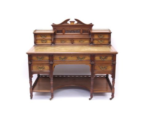 Good late 19th century walnut desk by James Shoolbred & Co., with galleried superstructure of short drawers, centred by carve