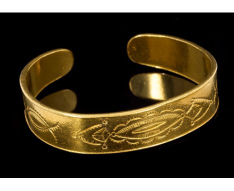 Eastern yellow metal torque bangle with stylised decoration CONDITION REPORT Total gross weight approximately 68.2 grams.  We
