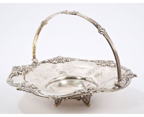 Victorian silver cake basket of dished circular form, with applied foliate border and embossed floral decoration, flower-head
