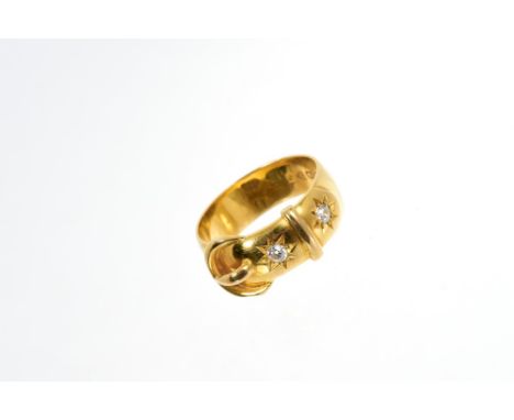 Edwardian 18ct gold and diamond set buckle ring with two old cut diamonds in star-shape setting (Chester 1909).  Ring size ap