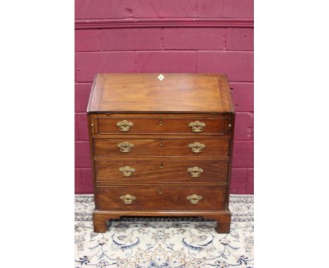George III mahogany bureau, the sloping fall enclosing fitted interior of short drawers and pigeonholes with four long gradua