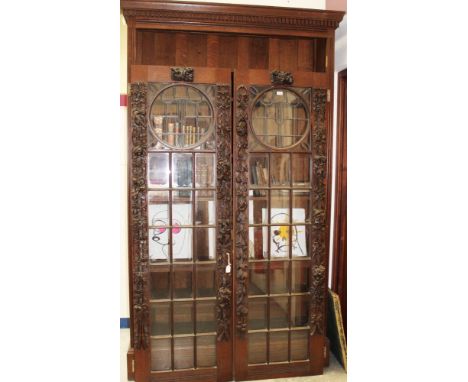 Late 19th / early 20th century carved oak bookcase enclosed by pair of Mackintosh-style leaded light astragal glazed doors, w